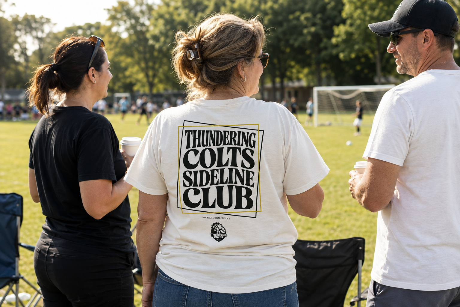Generated lifestyle scene of parents at a soccer game, showing the Sideline Club back design